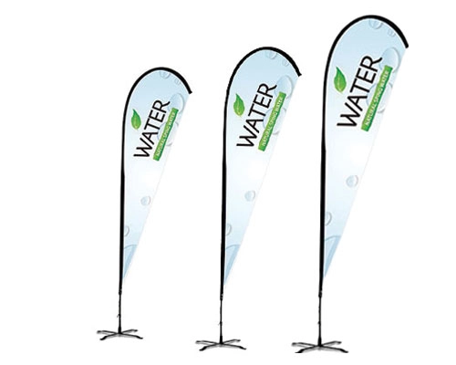 Feather-shaped teardrop flag with colorful branding at a trade show